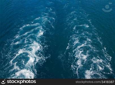 Water wake swirls background from ferry boat