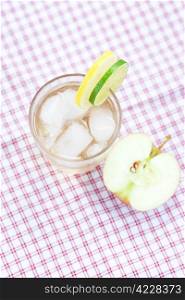 water with lemon and lime,apple in a glass with ice