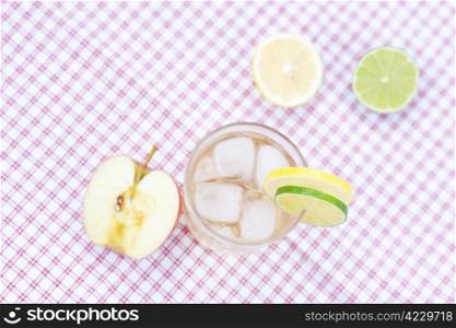 water with lemon and lime,apple in a glass with ice