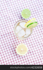 water with lemon and lime in a glass with ice