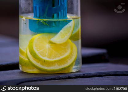 Water with lemon and rosemary herb in a flask