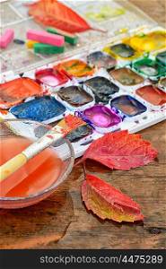 Watercolor paint,paint brush for painting and autumn leaves