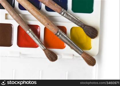 watercolor paints and art brushes isolated on a white background