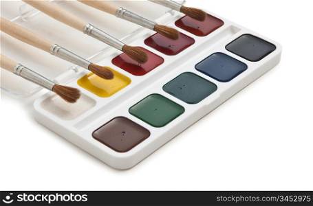 watercolor paints and brushes isolated on a white background