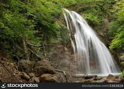 waterfall. A picturesque stream of falling water in mountains of the Crimean peninsula