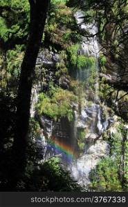 Waterfall and rainbow in the forest mountain, Nepal