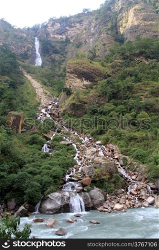Waterfall and river in mountain in Nepal