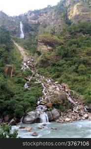 Waterfall and river in mountain in Nepal