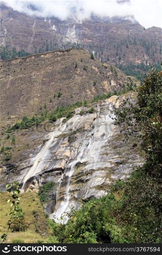 Waterfall and rock in mountain in Nepal
