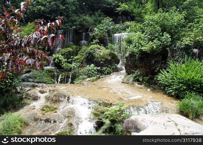 Waterfall and stones in park, Guilin, China