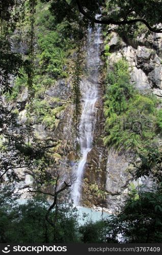 Waterfall and trees in mountain Nepal
