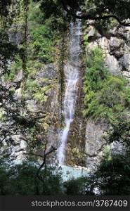 Waterfall and trees in mountain Nepal