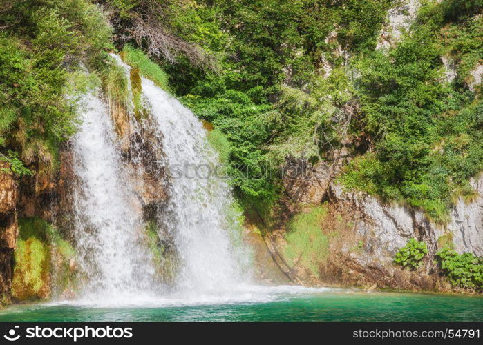 Waterfall at beautiful green summer forest lake. Plitvice Lake Nationak Park, Croatia