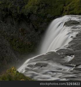 Waterfall cascade in verdant grassland