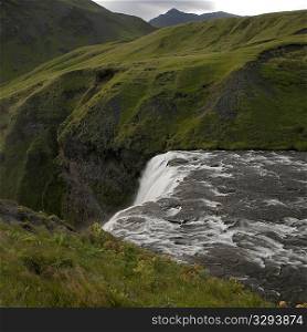 Waterfall cascade in verdant grassland