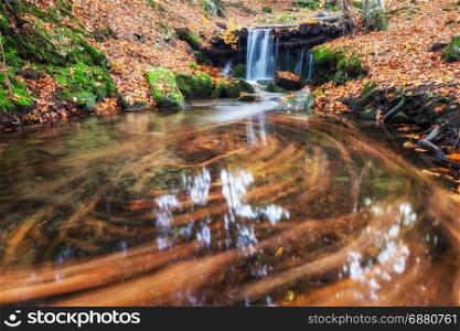 Waterfall in colorful autumn forest