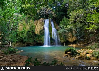 waterfall in deep green forest