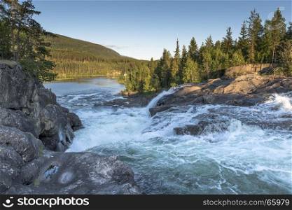 waterfall in norway near the jotunheimen national park in the villag Leira