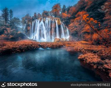 Waterfall in red forest in Plitvice Lakes, Croatia at sunset in autumn. Colorful landscape with fall, park, trees, orange foliage, water lilies, river. Scenery. Park in woods at dusk. Nature 