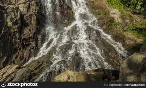 Waterfall in rocks background loop