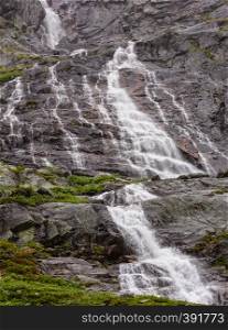 Waterfall in summer rocky mountain near Nigardsbreen Glacier, Jostedal, Norway