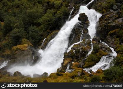 waterfall in the autumn woods, Briksdalen, norway