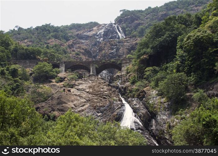 Waterfall in the jungle, a beautiful view of the railway on cliff .Indiya Goa.