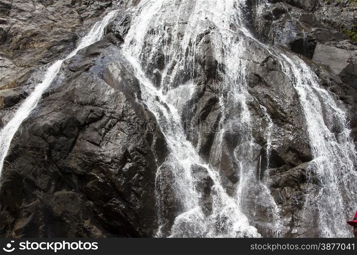 Waterfall in the jungle, a beautiful view of the steep rock .Indiya Goa.