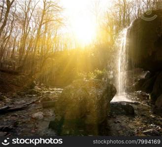 Waterfall in the wood at sunny morning