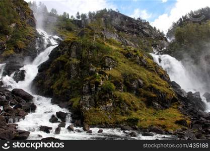 waterfall lotefossen in the autumn woods, norway