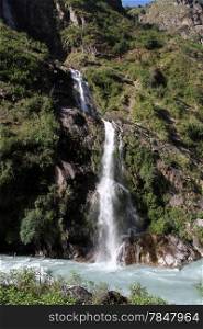 Waterfall on the rock and small mountain river in Nepal