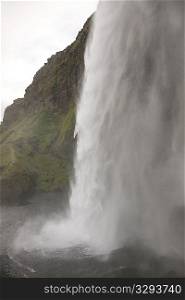 Waterfall over rocky cliffs in Iceland