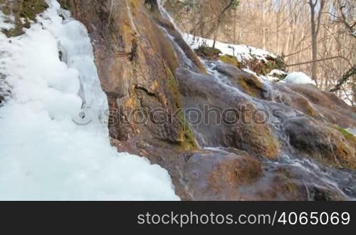 Waterfall Silver stream and mossy rock in winter. Grand Canyon, Crimea, Ukraine