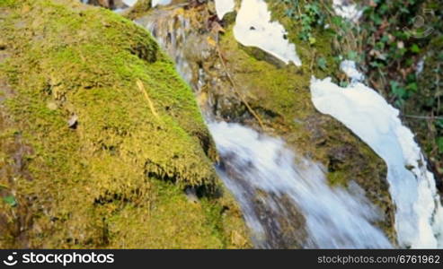 Waterfall Silver stream and mossy rock in winter. Grand Canyon, Crimea, Ukraine