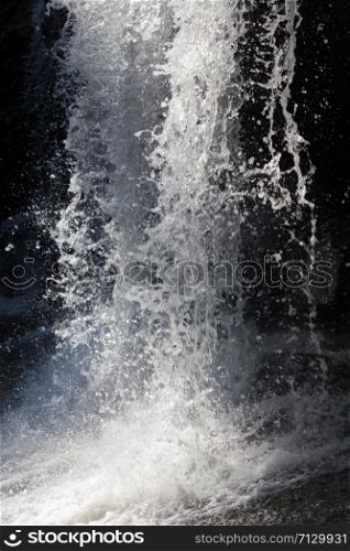 Waterfall stream. Black and white water spray