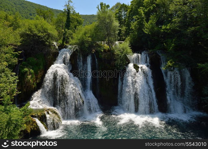 waterfall with clean and fresh water nature with green forest in background