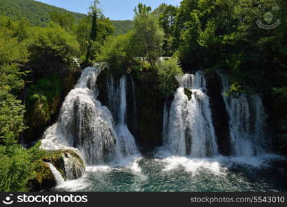 waterfall with clean and fresh water nature with green forest in background