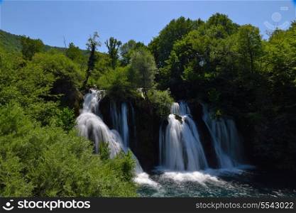 waterfall with clean and fresh water nature with green forest in background