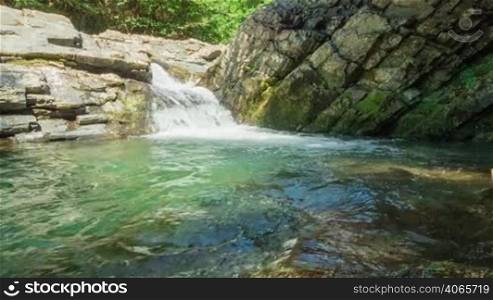 Waterfall with clear water in rocks