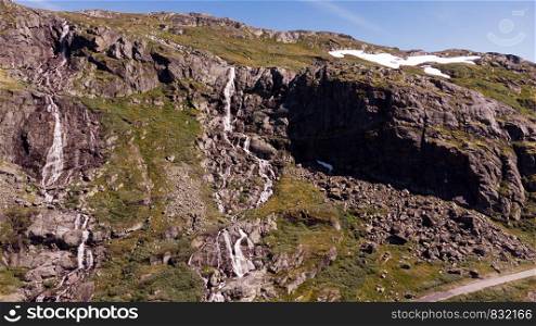 Waterfalls in mountains. National tourist scenic route 55 Sognefjellet between Lom and Luster, Norway. Summertime.. Waterfall in mountains. Norwegian route Sognefjellet