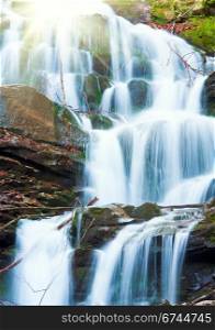 Waterfalls on Rocky Stream, Running Through Autumn Mountain Forest, and sunshine