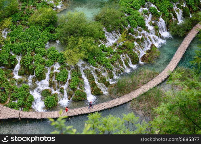 waterfalls on slopes of mountains and bridge&#xA;