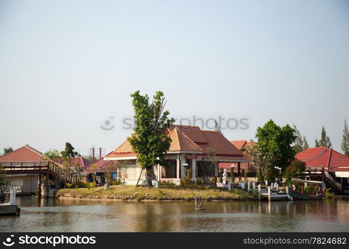 Waterfront home gardening in small yard. Water on the outside.