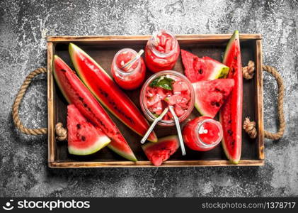 Watermelon cocktail on a wooden tray. On a rustic background.. Watermelon cocktail on a wooden tray.