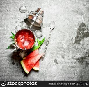 Watermelon cocktail with mint and ice in a shaker. On the stone table.. Watermelon cocktail with mint and ice in a shaker.