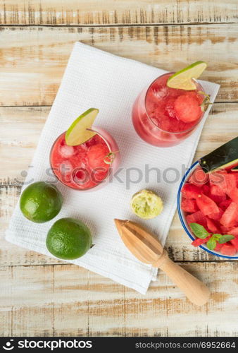 Watermelon fresh juice with mint leaves and lime citrus on wooden background