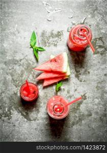 Watermelon juice with mint . On the stone table.. Watermelon juice with mint .