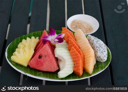 Watermelon, pineapple, papaya on a wooden table