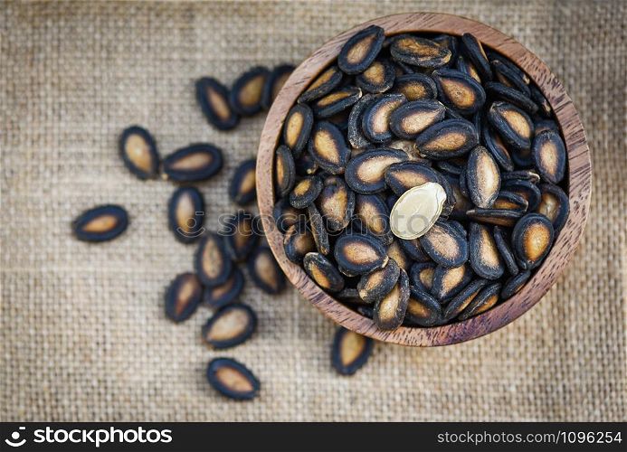 watermelon seeds in a wooden bowl / dried watermelon seed with salt for food or snack