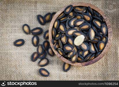 watermelon seeds in a wooden bowl / dried watermelon seed with salt for food or snack